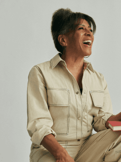 Elore team member smiling in a tan outfit