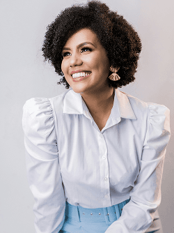 Elore team member in white blouse smiling at camera