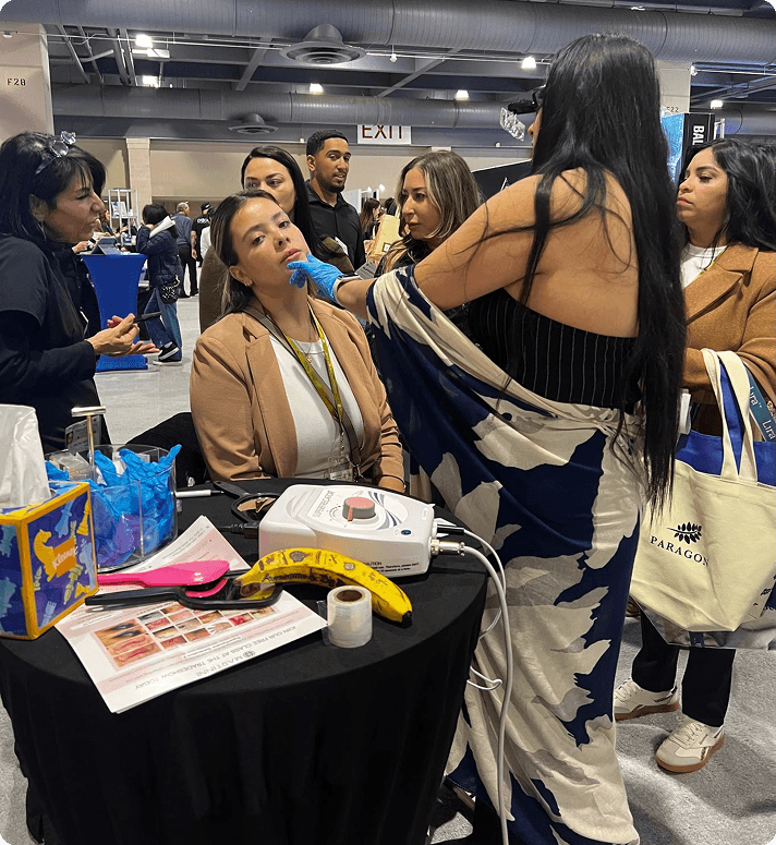 Elore professional giving a live skincare demonstration at a tradeshow booth